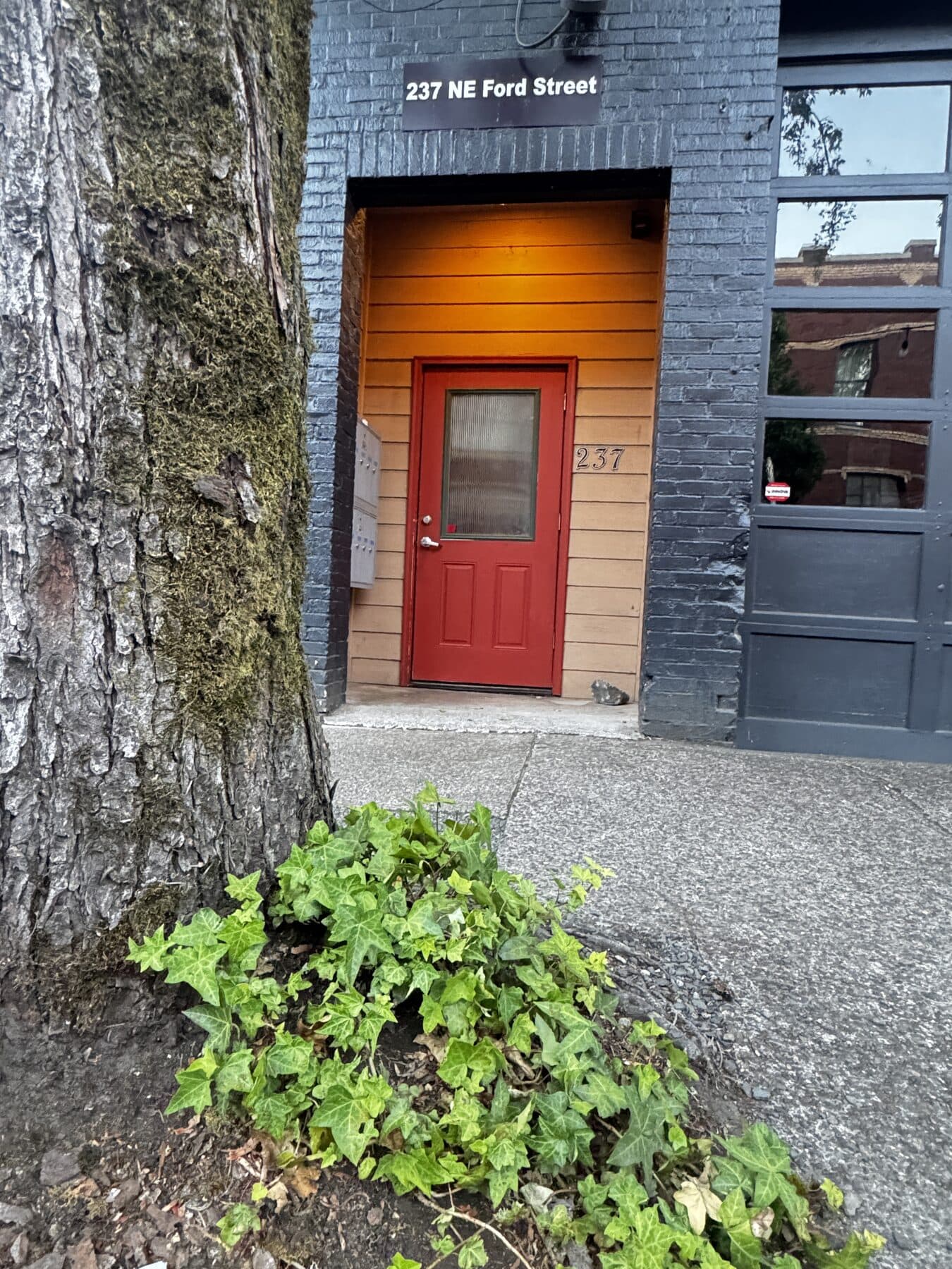 The red front door at 237 NE Ford Street, the entrance to Abraham Hanson Law's office in downtown McMinnville, Oregon