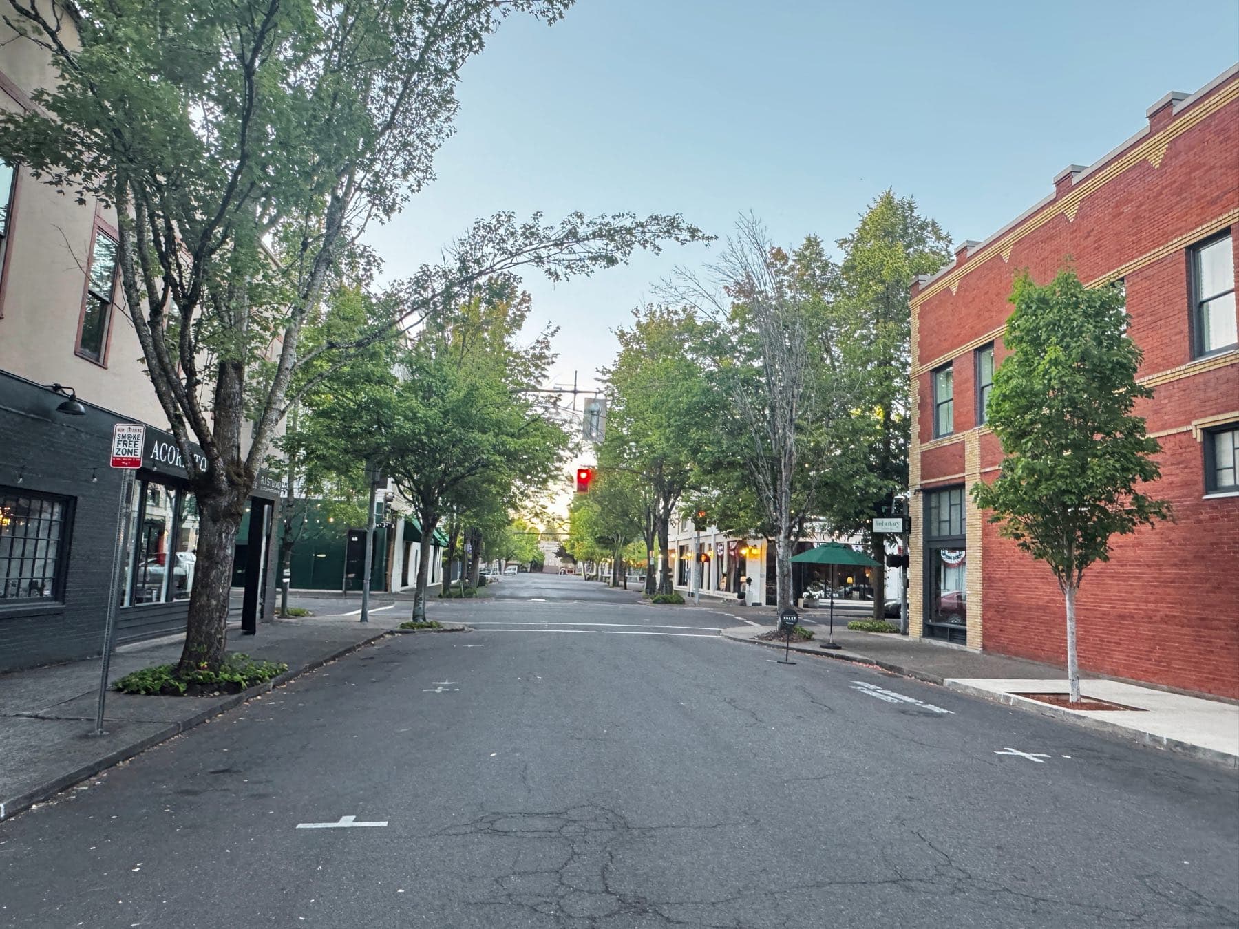 A quiet, tree-lined downtown McMinnville street a short walk from Abraham Hanson Law's office on NE Ford Street