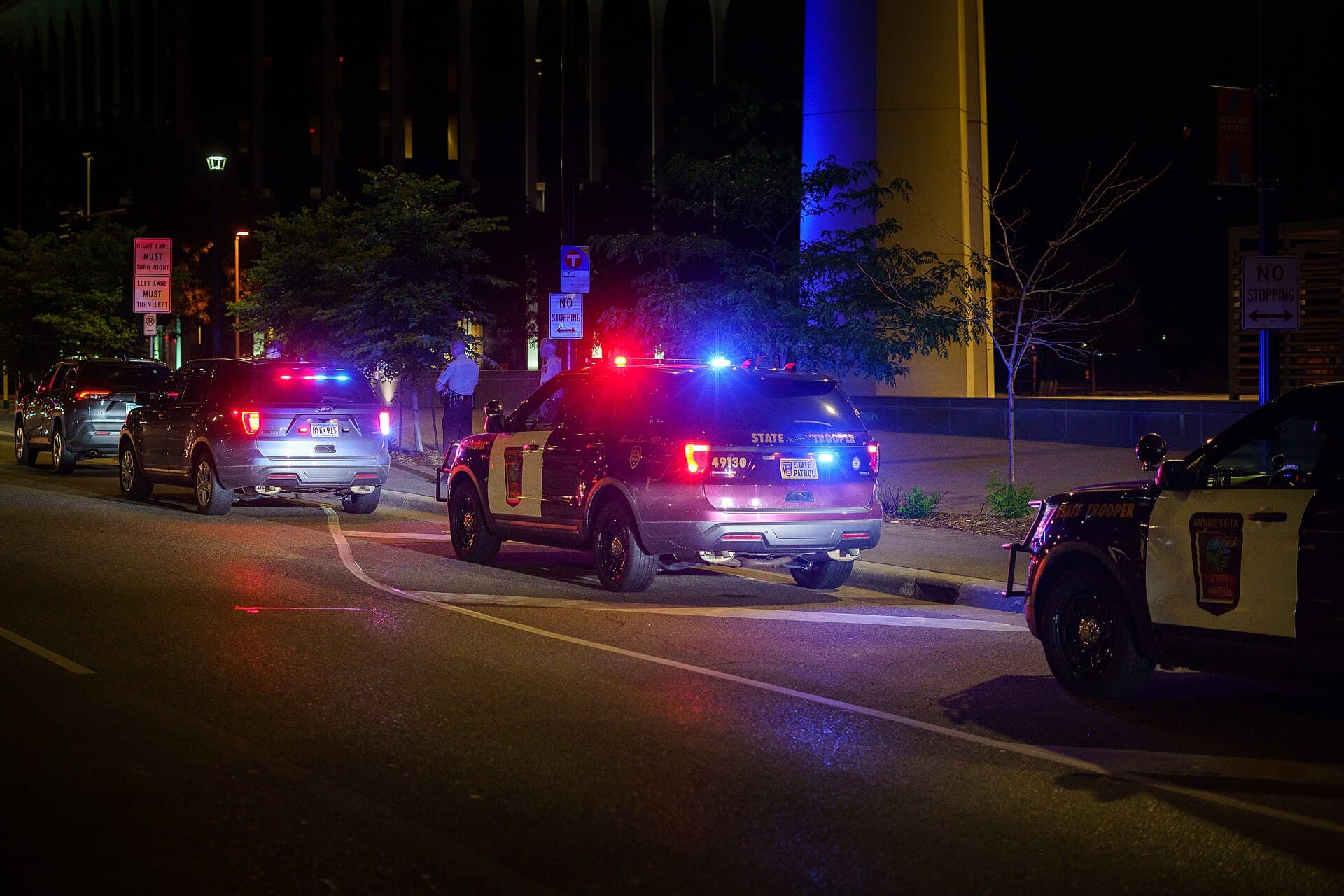Patrol cars with emergency lights during a nighttime traffic stop
